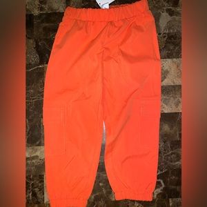 Orange cargo pants with pockets on the side